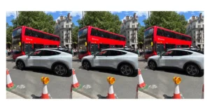 Self-driving car on a city road beside a London bus, used to prompt classroom discussion about future transport